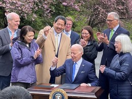 President Biden hands Mayor Harrell the pen from his Executive Order