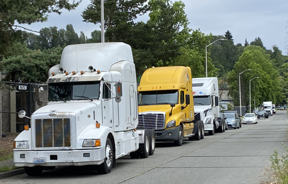 Trucks parked on the side of the street. 