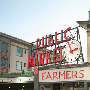 The red Pike Place Market sign that says "Public Market" with an analogue clock