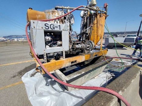 Image of machine showing how grout compound is pumped down through the bridge deck and into the post-tensioning ducts