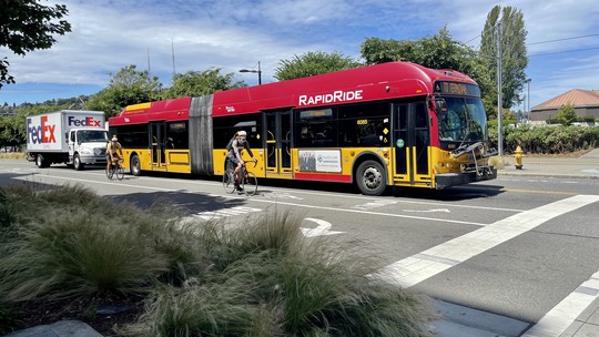 RapidRide bus and person biking