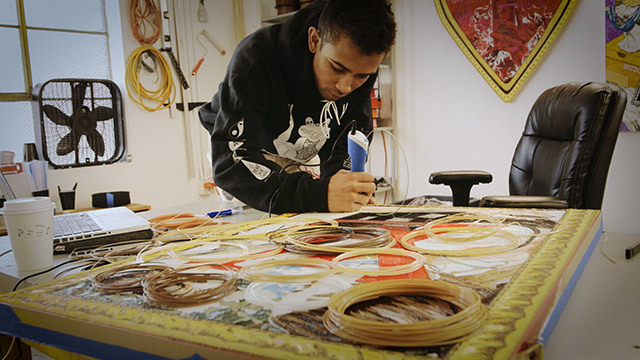 Anthony White creates a work of art in his studio