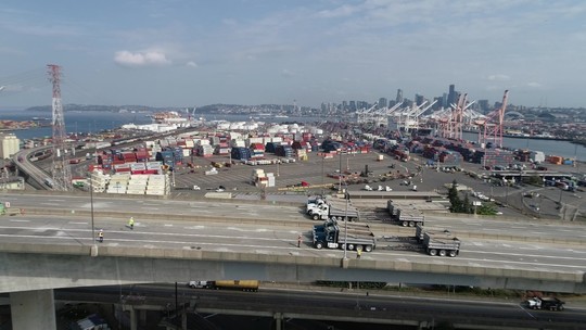 Trucks ready for load testing on the West Seattle Bridge’s eastern span, looking north toward the Port of Seattle and downtown. Photo: SDOT.