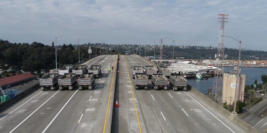 Twelve trucks lined up in preparation for load testing on the West Seattle Bridge earlier this week. Photo: SDOT.