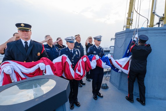 Seattle Fire and Seattle Police honor guard raise and lower the nation's flag in remembrance of 9/11