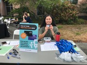Photo of a SDOT Transportation Access Programs employee tabling for Promise Scholar ORCA card distribution at South Seattle College
