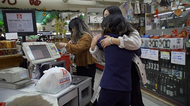 A Viet-Wah patron embraces a store staff member