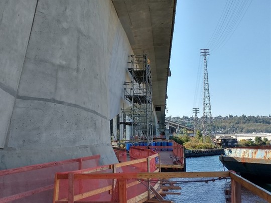 We assembled 4 work platforms and hoisted them up to the underside of the low bridge. 