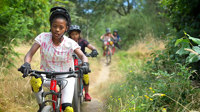 Youth bicycle through Cheasty Greenspace