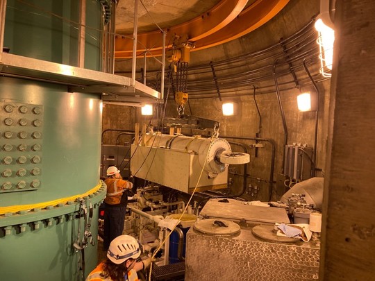 The 15,000-pound cylinder is hoisted onto an overhaul rail system. 