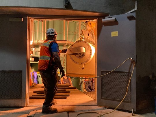 Our crew members guide the cylinder out of the bridge pier house.