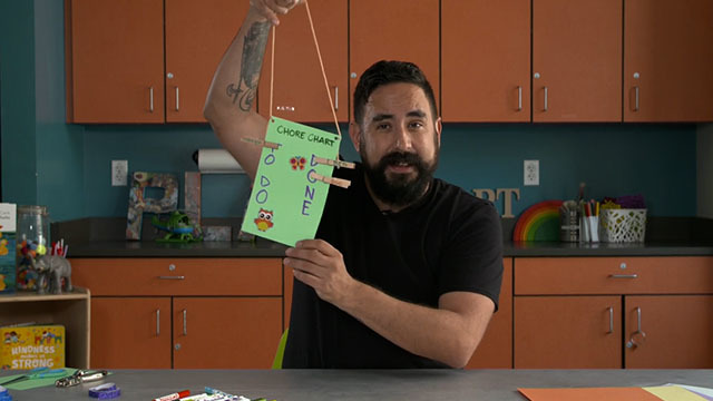 Bearded man holds green to-do list craft