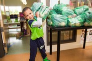 Photo provided by Tilth Alliance, showing Seattle Preschool Program student picking up his family’s Good Food Bag