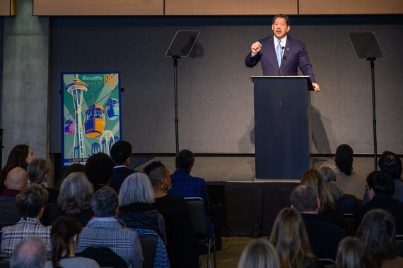 Mayor Harrell delivers his State of the City address with a poster of the Space Needle from the 1962 World's Fair that reads "The City of the Future."