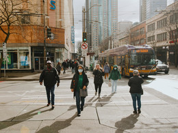 Pedestrians cross the street at Third Avenue and Pike Street