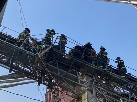 Firefighters rescue worker pinned on a conveyor belt