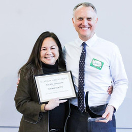 Natalie Thomson receives the MAX Award for her work on racial equity at HSD from former director Jason Johnson