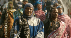 A scene from the Marvel movie, Wakanda Forever, with actors draped in blankets with Indigenous designs
