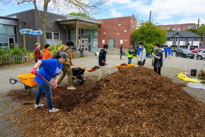 Volunteers shoveling mulch on the day of service at Garfield Superblock