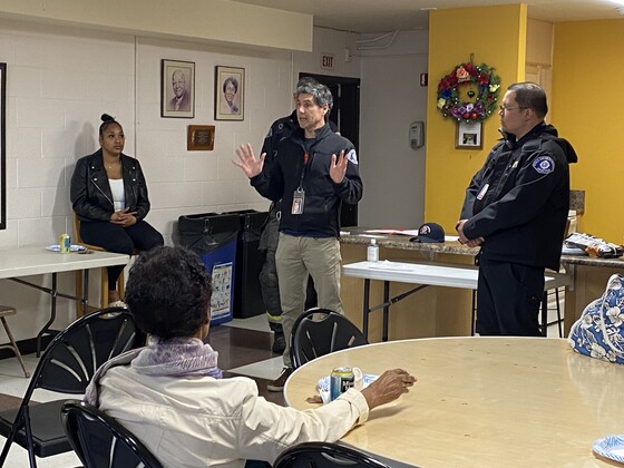 Seattle Fire Department staff members talking to residents about an apartment fire