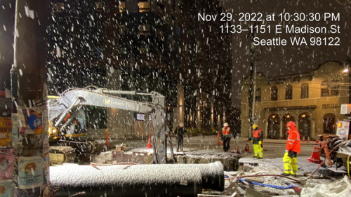 Crews working in the snow to install the new watermain
