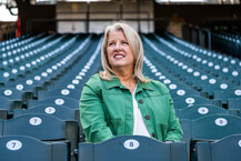 Portrait of Beth Knox smiling and sitting at T-Mobile stadium