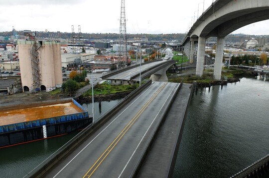 A photo of the Spokane St Swing Bridge as it swings open for a maritime vessel on the Duwamish Waterway. 