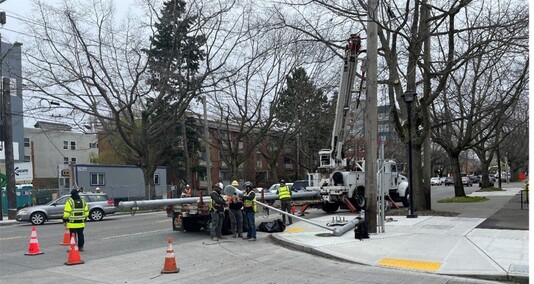Installing a signal pole at NW Market St and 11th Ave NW (Route 44).