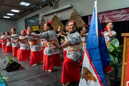Costumed Asian Pacific Islander dancers perform onstage