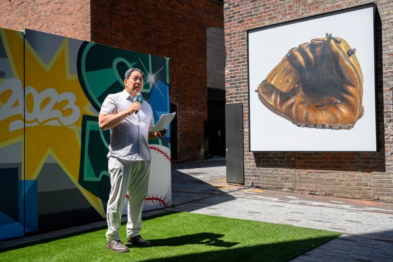 Mayor Harrell speaks in front of baseball murals