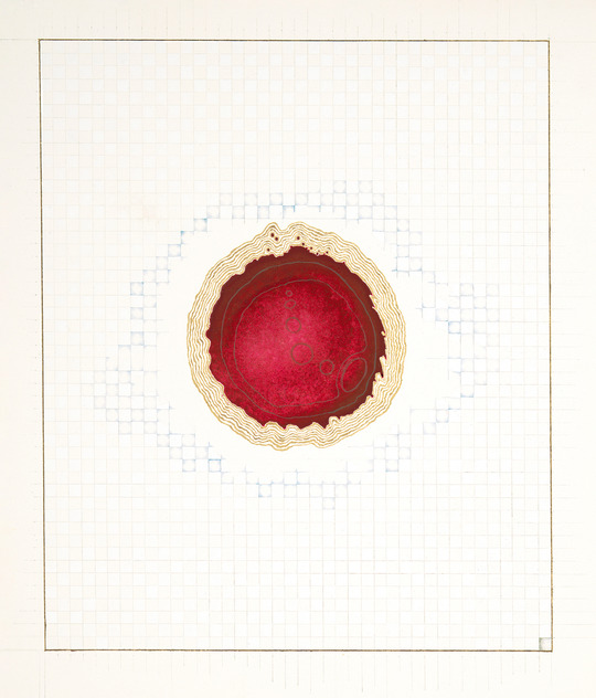 A beige paper with a red stain and cream ring around it.