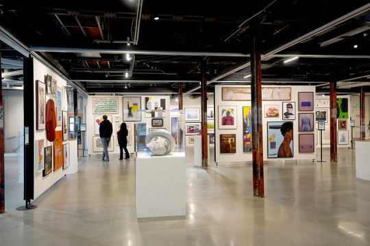 Two people looking at the artwork as part of the "The First 50 Years: Highlights from the Civic Collection, 1973-2023" exhibition.