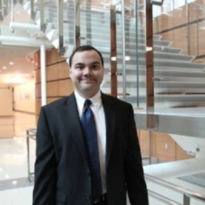 Image of a man standing in front of stairs