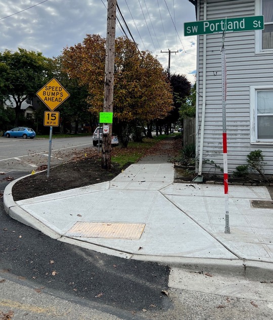 New sidewalk and ADA accessible ramp on the southwest corner of Highland Park Way Southwest and Southwest Portland Street