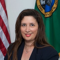 Headshot of Bonnie Glenn, OPA's new deputy director. Bonnie has shoulder length brown hair and is wearing a navy blue blazer.