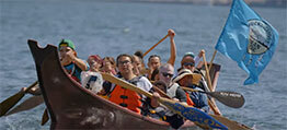 Members of the Muckleshoot on the water in a traditional canoe
