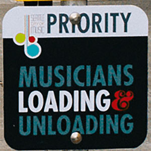 Street sign reading Prioroty  Musicians Loading & Unloading
