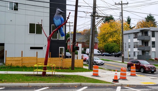 17-foot-tall sculpture of a Steller's jay sitting on a branch at the corner of Highland Park Way Southwest and Southwest Holden Street