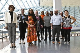 A group of ten employees on the Procurement Transformation project smile for a photo during a team retreat