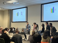 A team presenting their data visualization at the hackathon. 