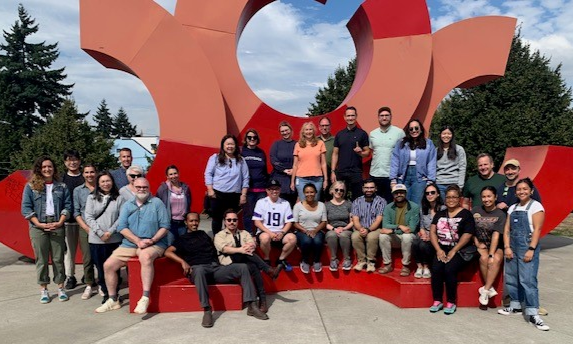 Group of OED Staff Members in front of red art installation