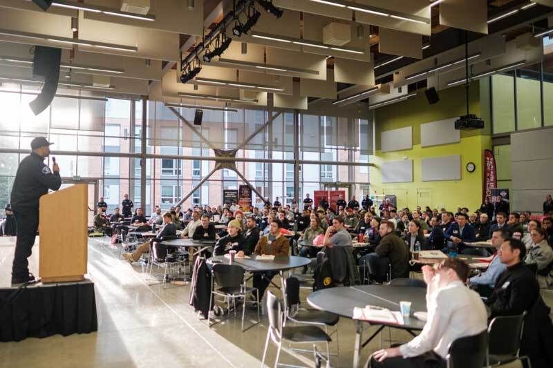 Firefighter speaks to an audience of people interested in the career during the King County Diversity and Recruitment Workshop