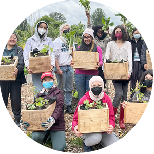 Group of young people standing in a greenhouse after volunteering.