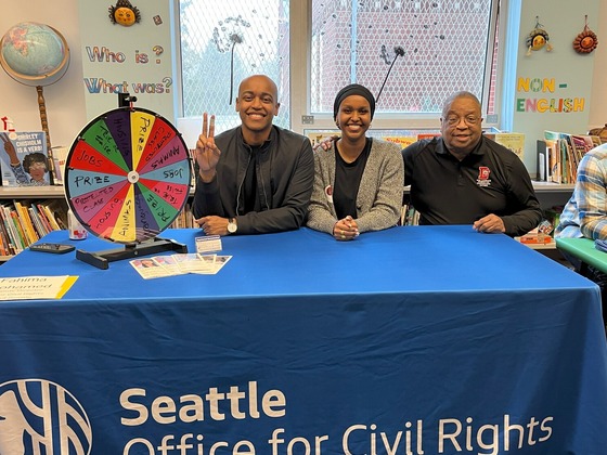 OCR Deputy Director Fahima Mohamed pose for a photo alongside current & former King County Councilmembers Girmay Zahilay and Larry Gossett.