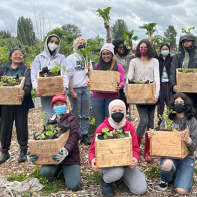 A group teens standing in a farm field and after working