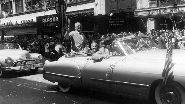 President Truman rides in a car in a downtown Seattle parade.