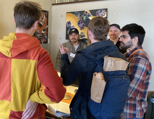 Outreach team members speak to community members at recent coffee chat