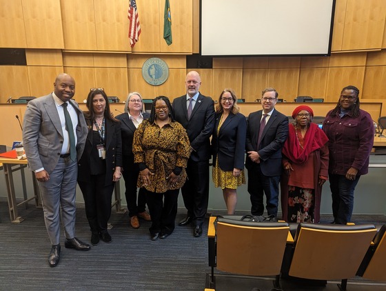 Police accountability partners take a picture with Seattle City Council Public Safety Committee Chair Robert Kettle