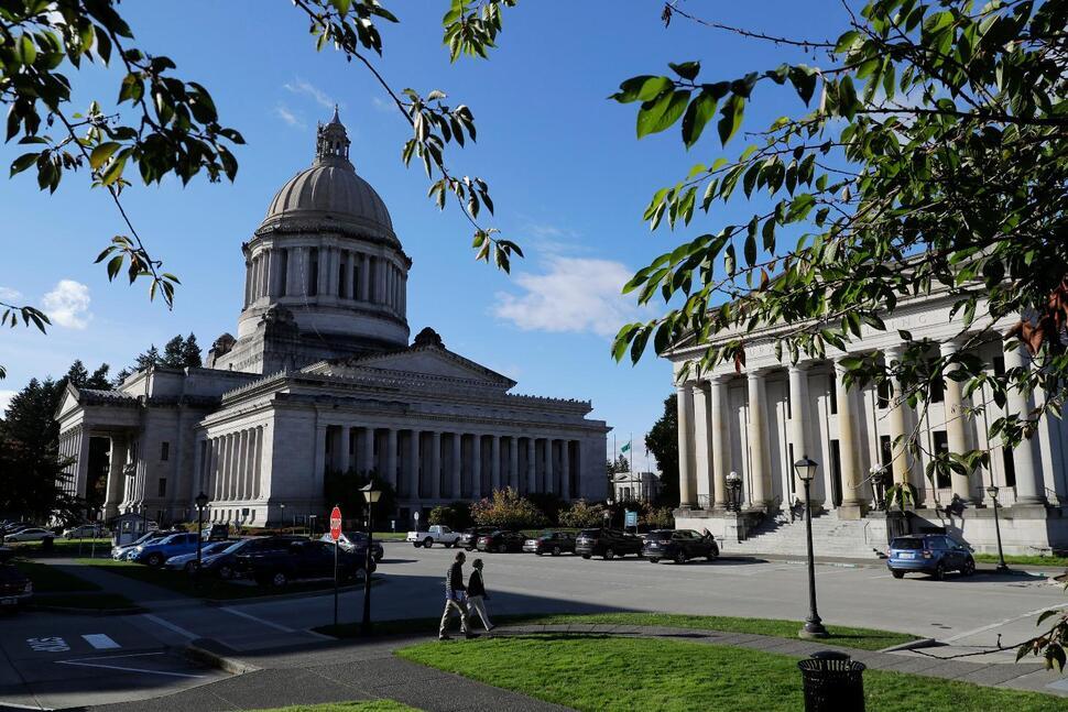 People walk outside the state capitol in Olympia, WA. Photo Credit: Ted S. Warren/U.S. News