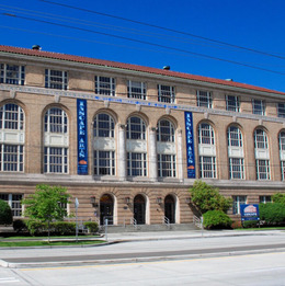 An exterior of a building with blue banners on the front